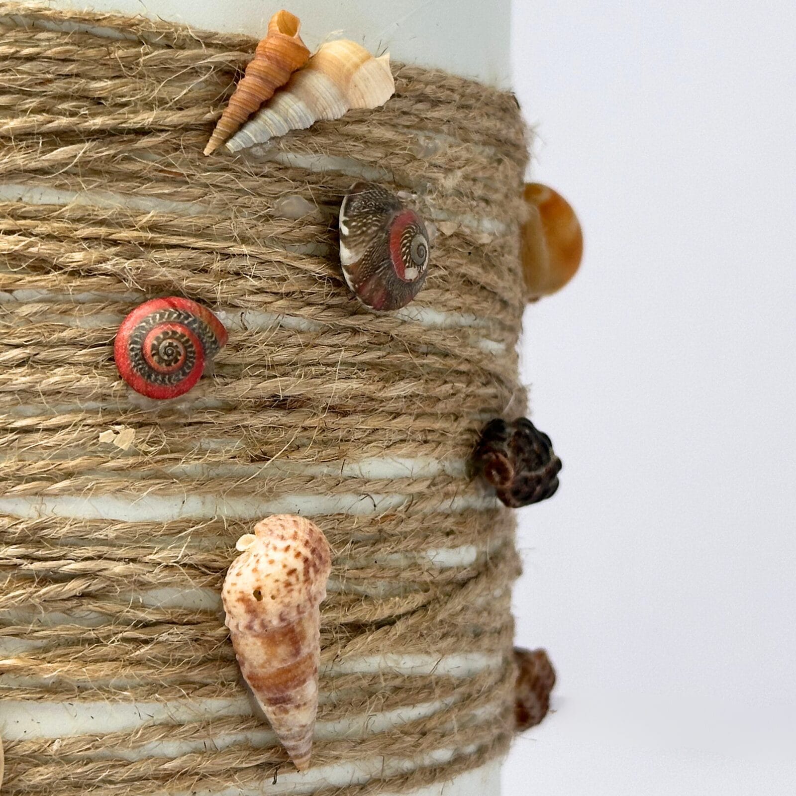 Repurposed bottle decorated with coastal shell details