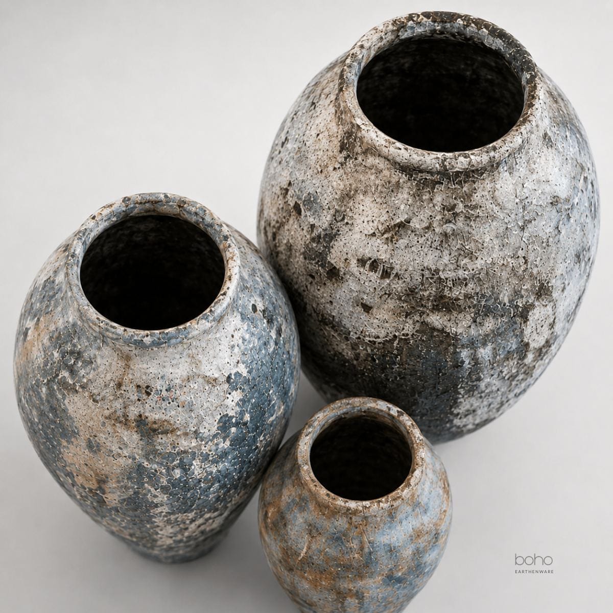A sculptural trio of handcrafted terracotta vessels featuring blue-grey mineral patina, weathered textures, and ancient-inspired beauty. Perfect for contemporary, rustic, coastal, and artfully curated interiors.
